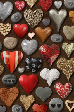 Background of heart-shaped things made of stone, metal and wood. clipart