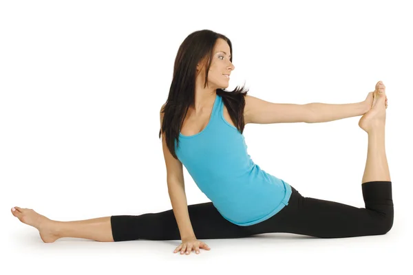 stock image Young attractive women in her early 20's showing her flexibility doing the splits.