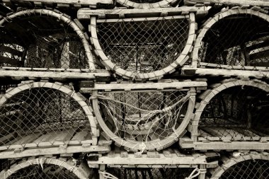 An image of old lobster traps resting by the sea. clipart