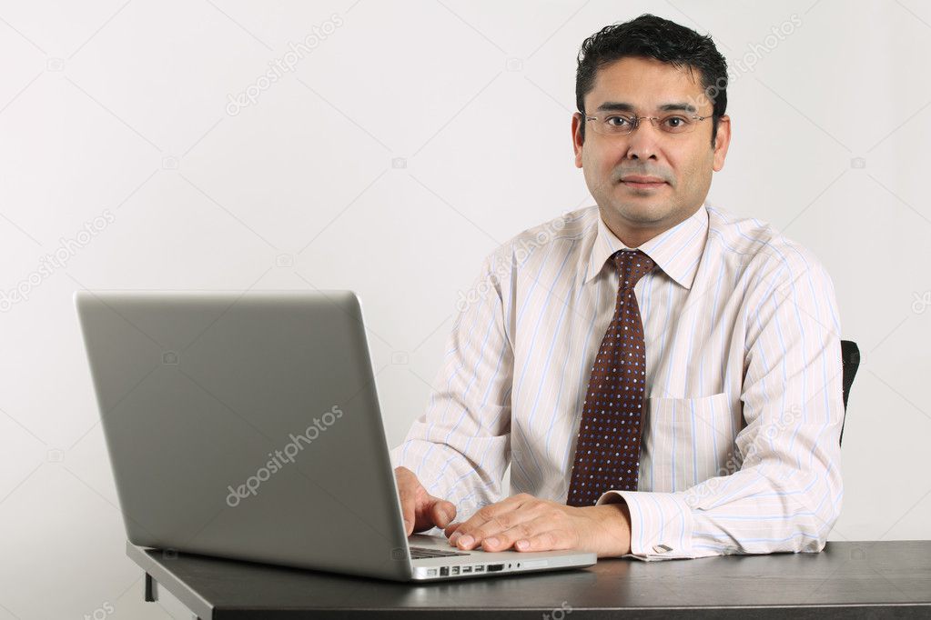 Indian businessman working on laptop