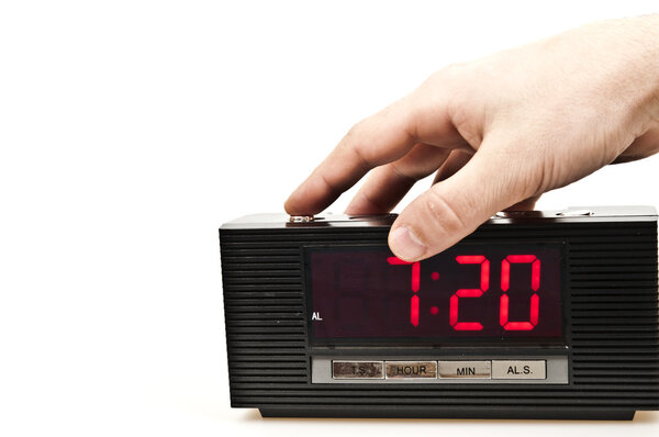 Male hand stopping alarm clock