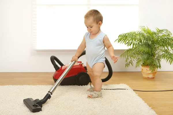 Baby boy with vacuum cleaner — Stock Photo, Image