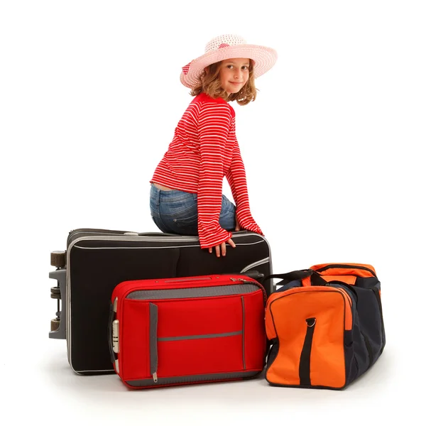 Girl sitting on luggage — Stock Photo, Image