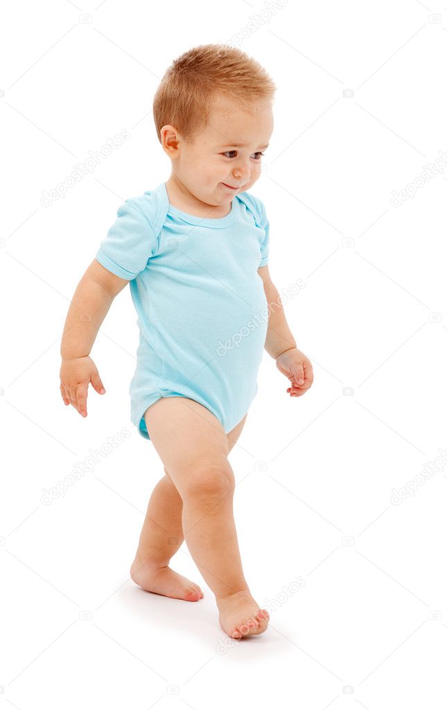 Baby boy walking slyly. Isolated on white