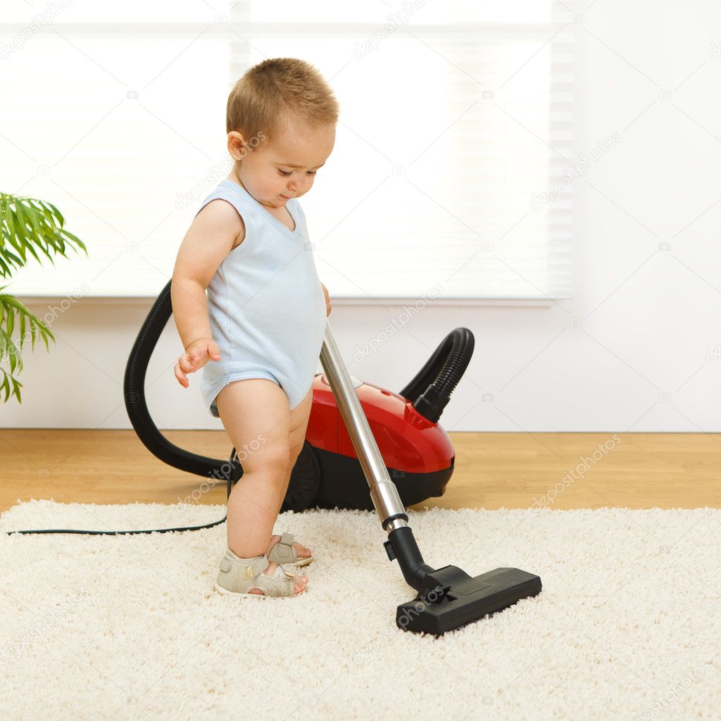 Baby boy with vacuum cleaner