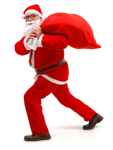 Santa Claus caminando con el bolso lleno — Foto de Stock