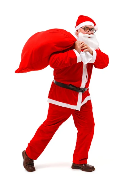 Santa Claus caminando con el bolso lleno — Foto de Stock