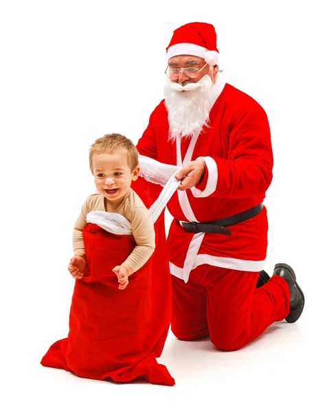Niño en la bolsa de Santa Claus — Foto de Stock