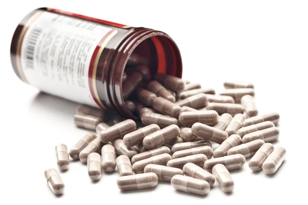 stock image Medicinal pills poured out of the jar