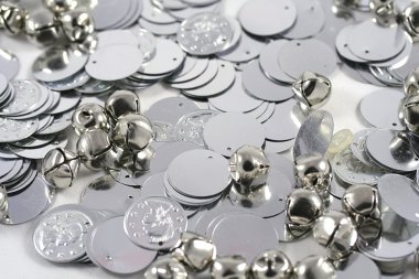 Close up of bells and plastic coins. clipart