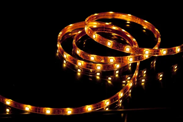 stock image Glowing LED garland on black background