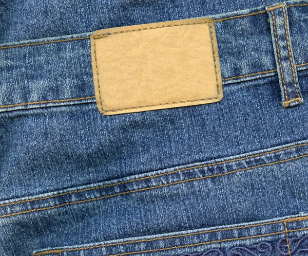 Blank leather label on jeans — Stock Photo, Image