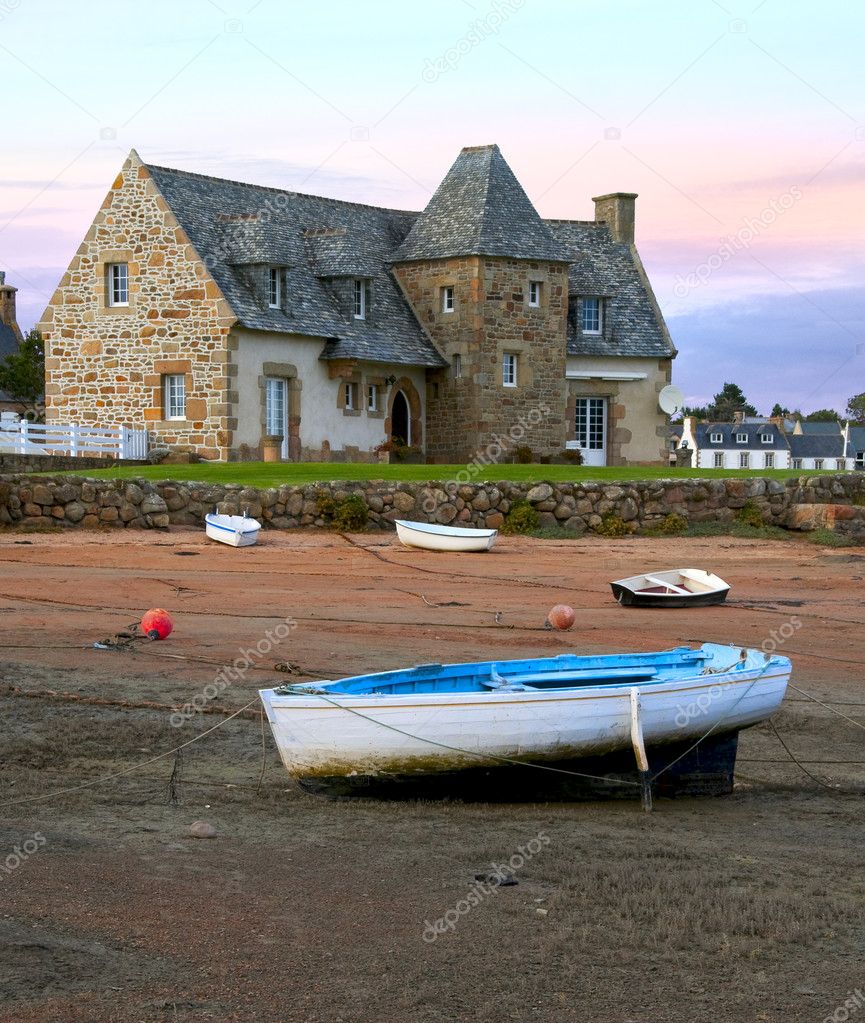 Ancient house and boats on a mooring - beautiful scenery at sunset
