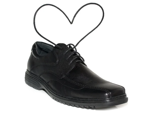 Zapatos negros con un encaje un tipo de corazón en el blanco — Foto de Stock