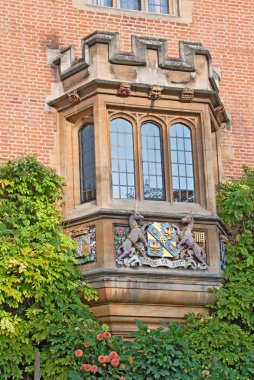 Bay-window with heraldic symbols in Cambridge, UK clipart
