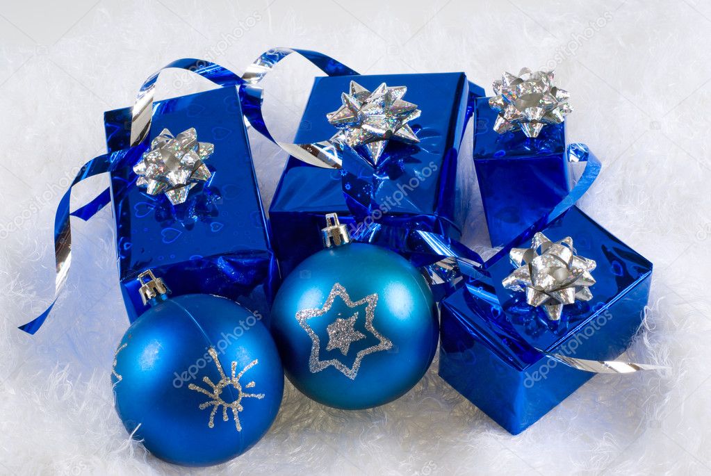 Blue boxes and Christmas blue balls are on the white fur
