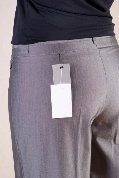 Trying on of the grey trousers in shop — Stock Photo, Image