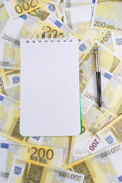Schreibbuch mit Stift auf Banknoten 200 Euro — Stockfoto
