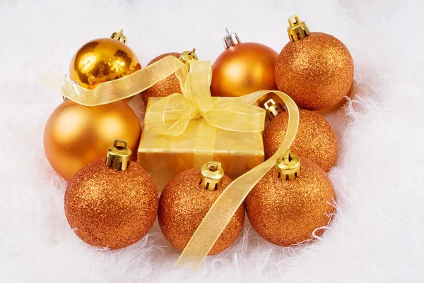 Christmas spheres and box on the white fur — Stock Photo, Image