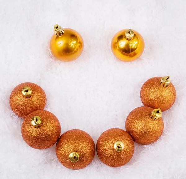 Christmas brightly golden spheres on the white fur — Stock Photo, Image