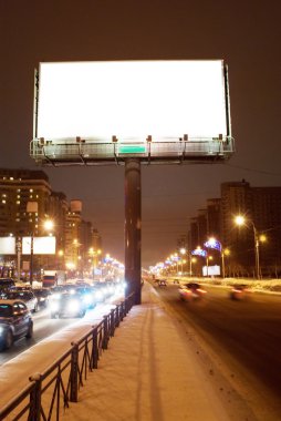 Big white billboard on the night street clipart