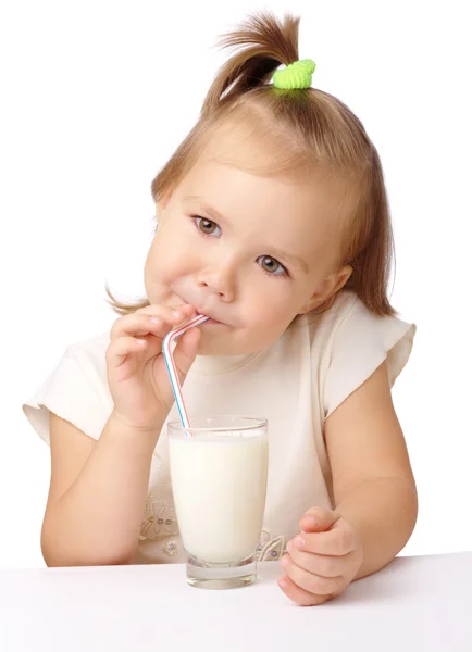 Little girl drinks milk using drinking straw — Stock Photo, Image