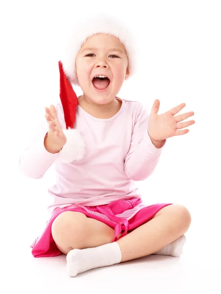 Little girl wearing red Christmas cap — Stockfoto