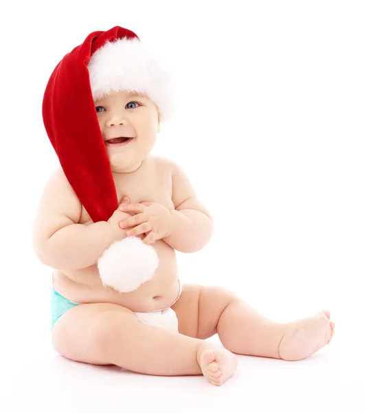 Little child wearing red Christmas cap Royalty Free Stock Images