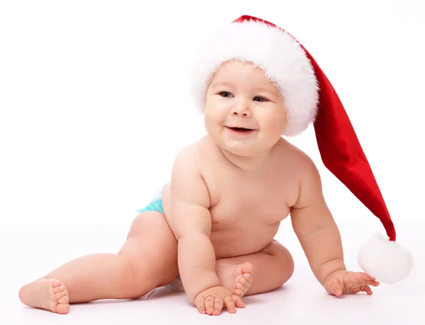 Piros karácsonyi sapkát visel kisgyermek — Stock Fotó