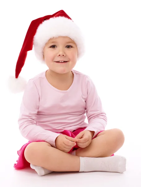 Little girl wearing red Christmas cap — Stockfoto