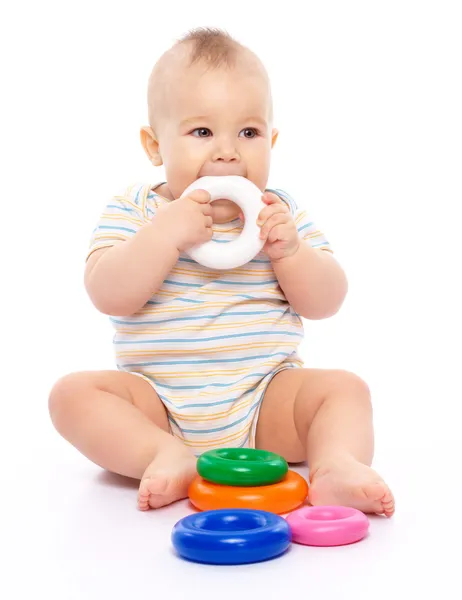 Cute Little Boy Playing Toys Biting One Them While Sitting — Stock Photo, Image