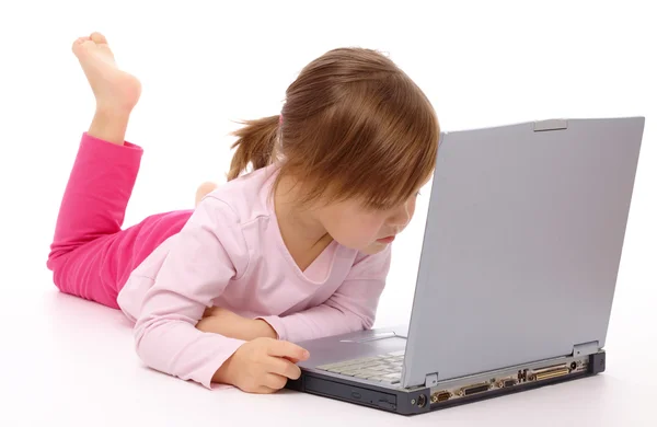 可爱的小女孩用她的笔记本电脑 孤立白上躺地板上 — 图库照片
