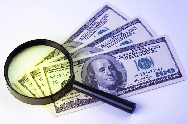 Dollars under a magnifying glass — Stock Photo, Image