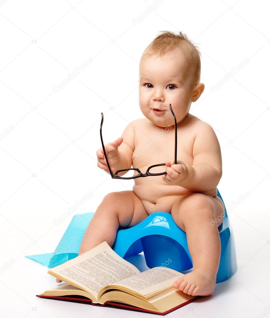 Child on potty play with glasses and book, isolated over white