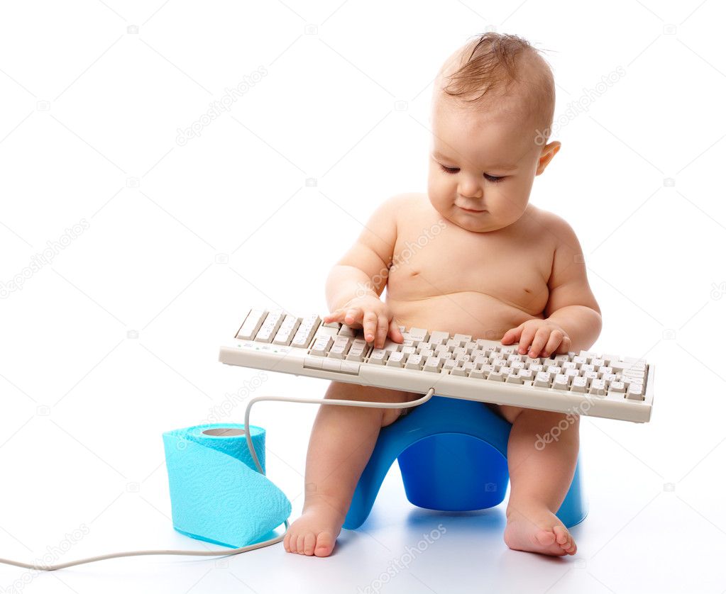 Little child is typing on keyboard