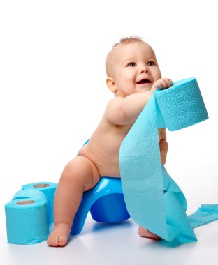 Child on potty play with toilet paper, isolated over white clipart