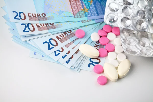 Stock image Few pills over Euro money