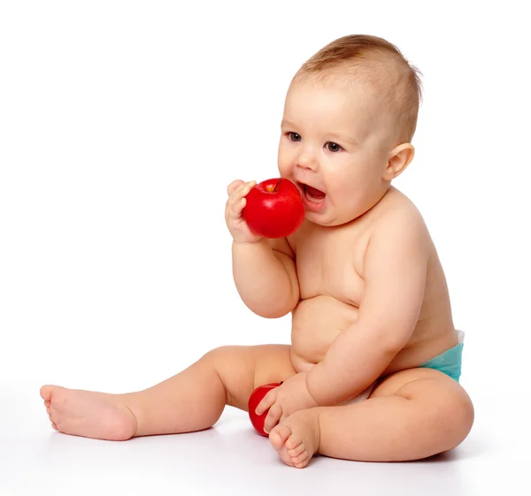 Le petit enfant va mordre la pomme rouge — Photo