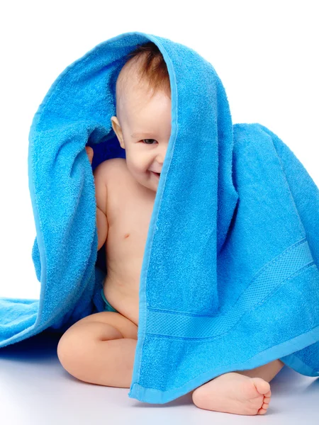 Mignon enfant enveloppé dans une serviette bleue — Photo