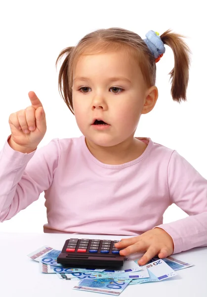 Little girl plays with money Stock Picture
