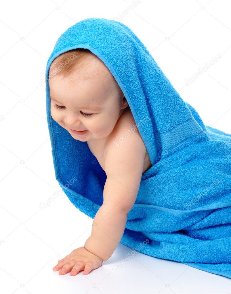 Cute child wrapped in blue towel