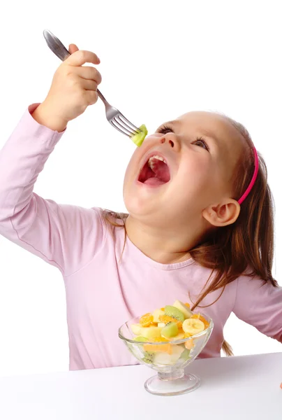 Little girl eats fruit salad — Stock Photo, Image