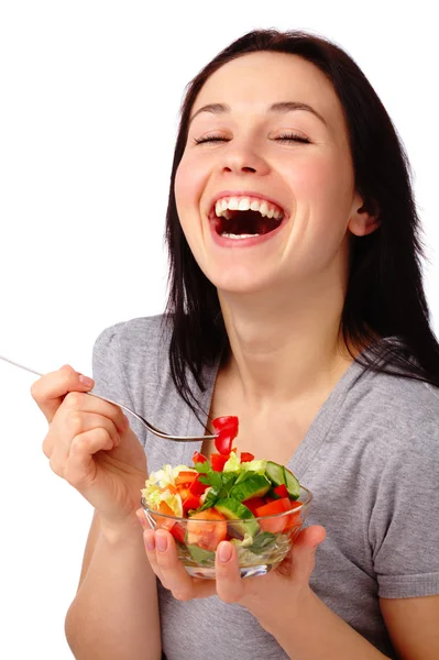 Jovem mulher atraente come salada de legumes — Fotografia de Stock