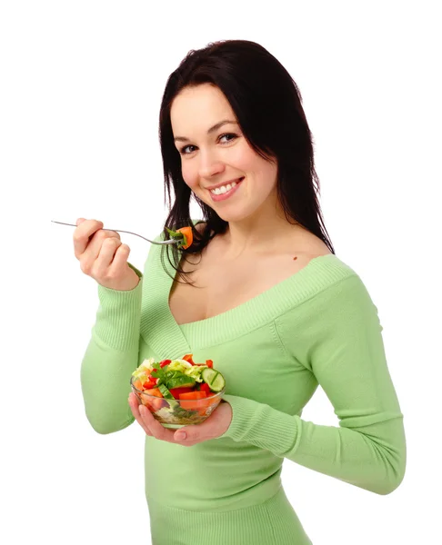 Jovem mulher atraente come salada de legumes — Fotografia de Stock