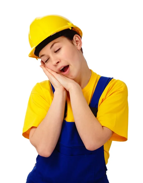 Jovem mulher em uniforme de construção está bocejando — Fotografia de Stock