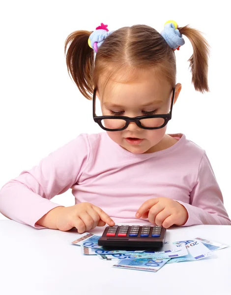 Little girl plays with money — Stock Photo, Image