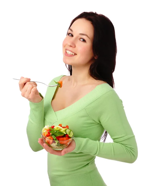 Jovem mulher atraente come salada de legumes — Fotografia de Stock