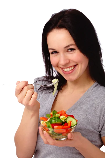 Young attractive woman eats vegetable salad Stock Picture