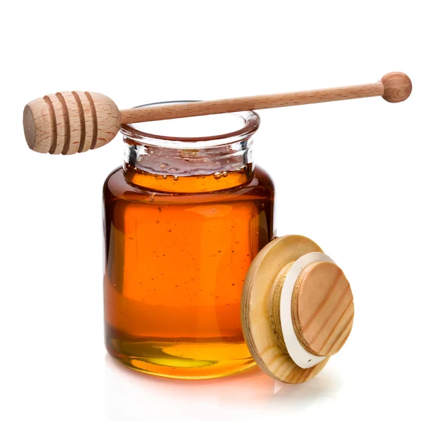 Honey jar and dripper — Stock Photo, Image