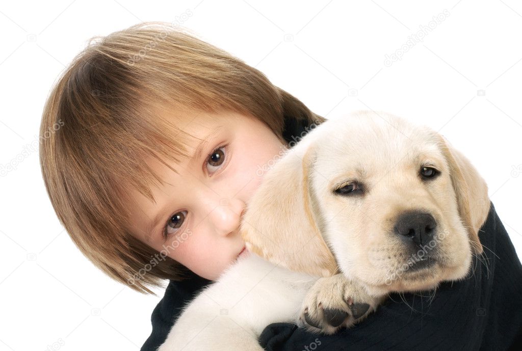 Child holding puppy